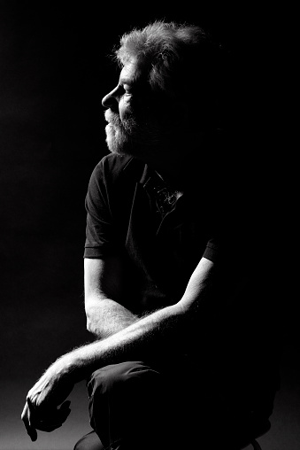 Old man posing for studio photography as thinking man