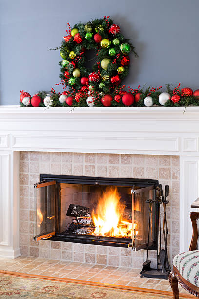 istock Christmas fireplace with baubles and blazing fire 621604256