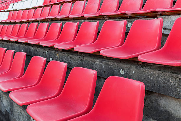 istock Football stadium bleachers red chairs 621605432
