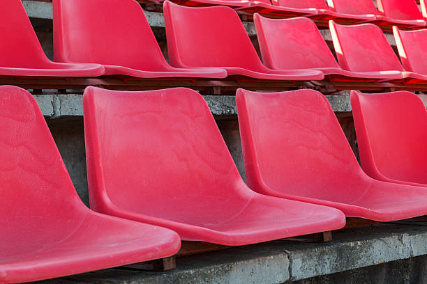 istock Football stadium bleachers red chairs 621605684