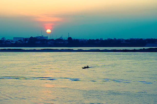 Small traditional boat on the River Mekong at sunset, Savannakhet, Laos