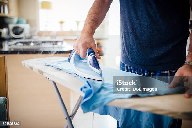 Man Ironing Laundry Stock Photo - Download Image Now - Iron - Appliance, Men, Ironing Board
