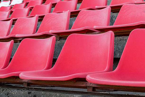istock Football stadium bleachers red chairs 621605896