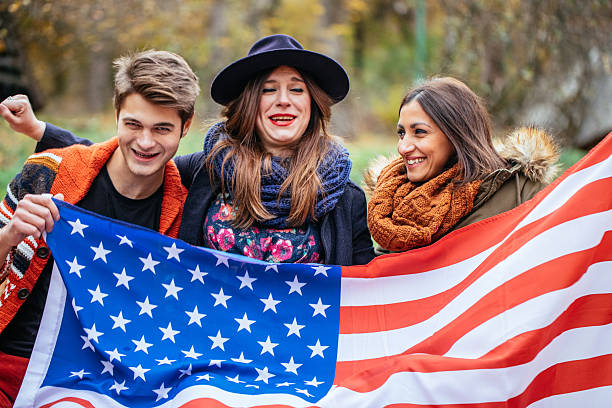 istock Friends holding american flag 621605948