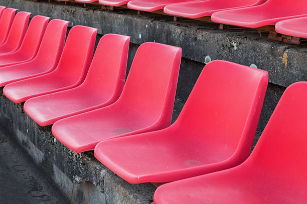 istock Football stadium bleachers red chairs 621606102