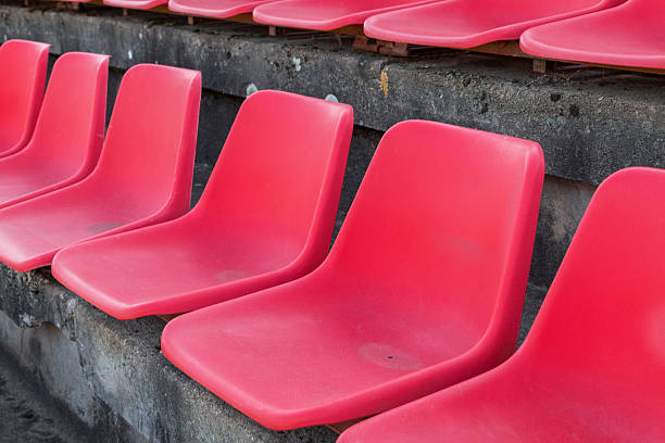 istock Football stadium bleachers red chairs 621606302