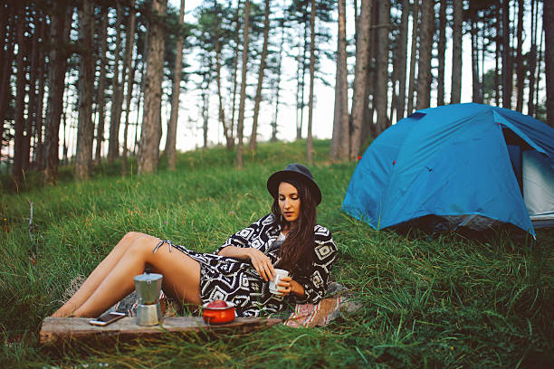 istock Young woman camping in the forest 621607978