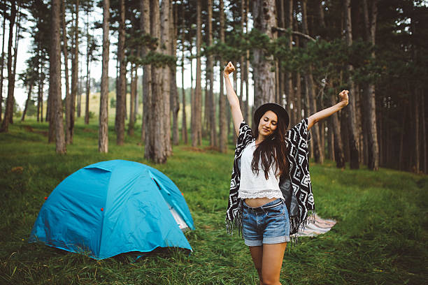 istock Young woman camping in the forest 621608214