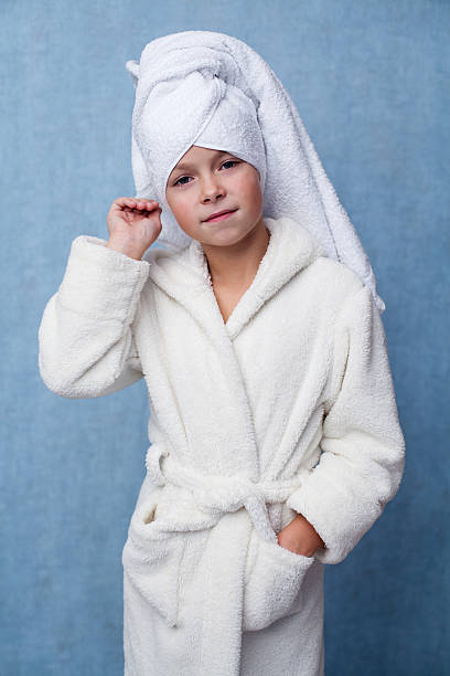 istock Little beautiful girl in a white bathrobe 621608282