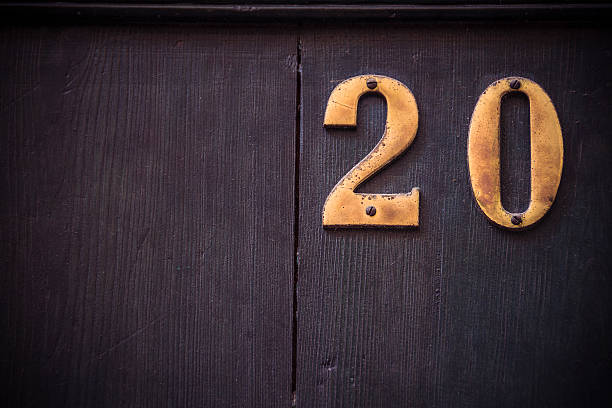 istock Metal number twenty with large dark wooden background 621608708
