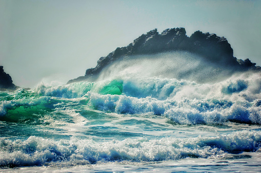 Large stormy waves crashing on to the shore.