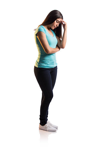 istock Worried young latin woman standing and touching forehead 621610214