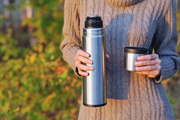 istock Woman holding thermos 621610948