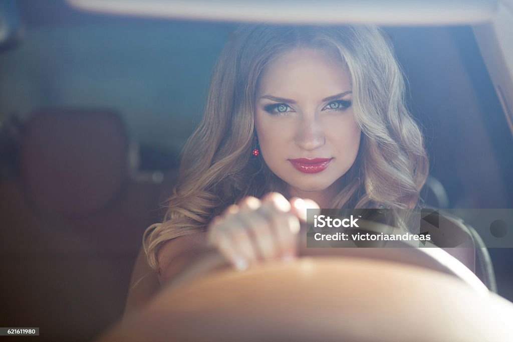 Beautiful Smiling woman driving car, attractive girl sitting Beautiful Smiling woman driving car, attractive girl sitting in automobile, outdoors summer portrait. Car Stock Photo