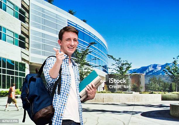 Smiling Student Pointing At Camera Stock Photo - Download Image Now - Brigham Young University, 20-29 Years, 25-29 Years