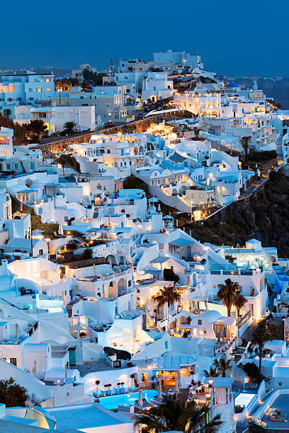 Fira Town at Dusk, Santorini, Cyclades Islands, Greece View of white clustered buildings of Fira town with domed roof of church at dusk, Santorini Island, Greece. Long exposure with tripod, 50 megapixel image. fira santorini stock pictures, royalty-free photos & images