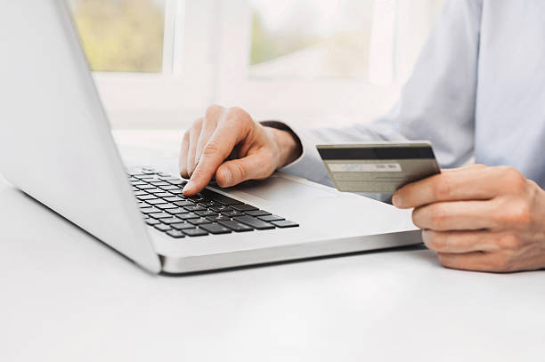 istock Man is shopping online with laptop 621614376
