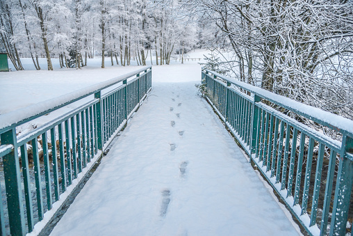 Winter wood landscape, walk bridge cover snow with white forest 