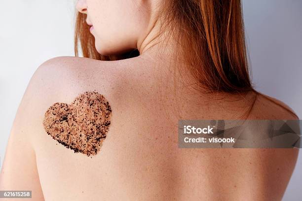 Woman With Coffee Scrub In A Heart Shape On Back Stock Photo - Download Image Now - Exfoliation, Back, Facial Mask - Beauty Product