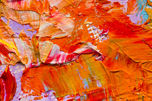 Artist's palette with mixed oil paints, macro, colorful stroke texture on canvas, studio shot, abstract art background 