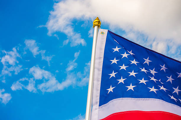 istock American flag against a blue sky 621686322