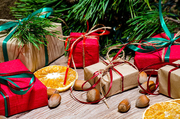 istock Boxes with gifts and hazelnuts under the Christmas tree 621686554