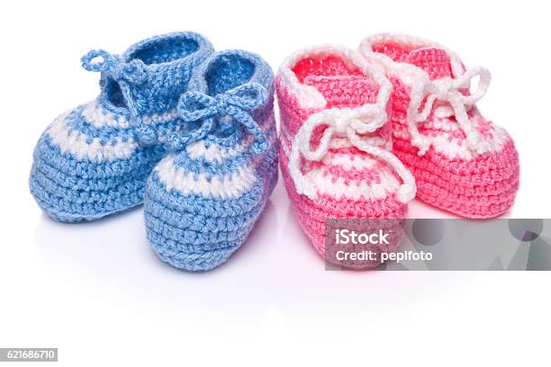 Homemade Knitted Baby Blue And Pink Booties Stock Photo - Download Image Now - Twin, Baby - Human Age, Cut Out