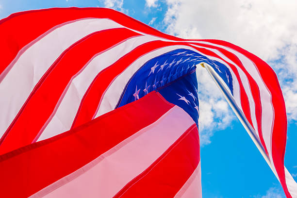 istock American flag against a blue sky 621687074