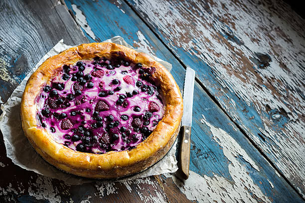 istock Homemade pie with bilberry on old wooden table. 621687162
