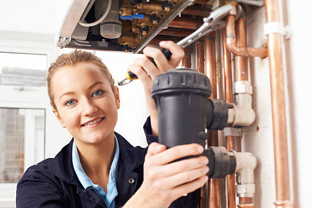 istock Female Plumber Working On Central Heating Boiler 621688142