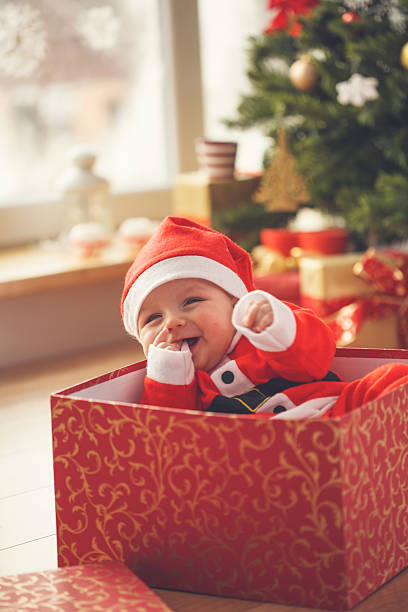 istock Baby boy in Christmas present 621688520
