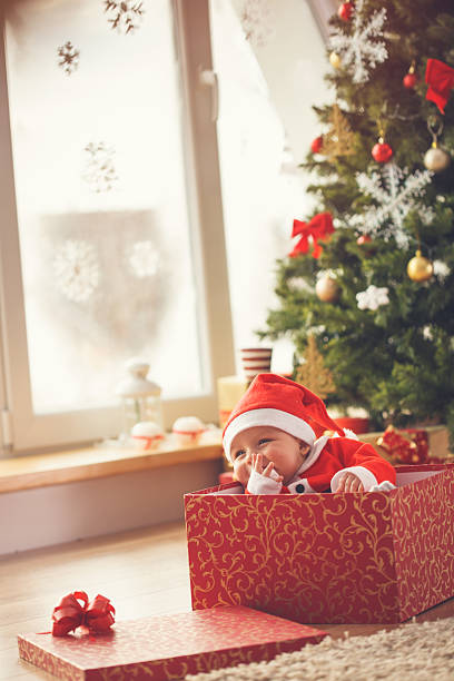 istock Baby boy in Christmas present 621688538