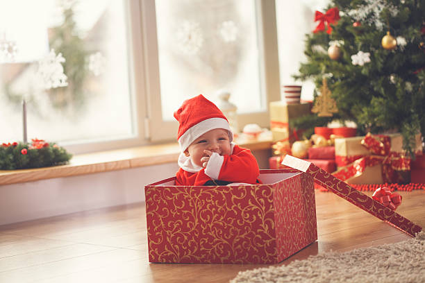istock Baby boy in Christmas present 621688556
