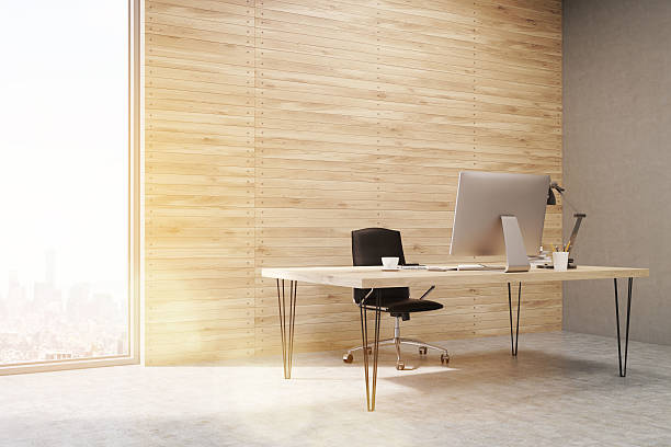 Side view of CEO working desk in office with panels