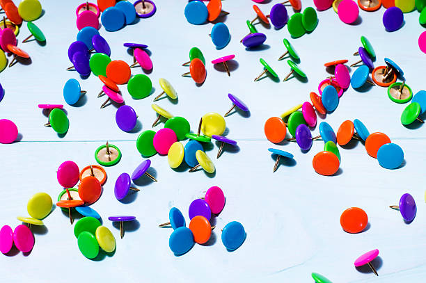 istock Colorful push pins on blue wooden background, close up. 621693942