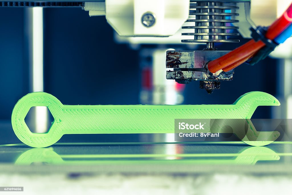 3d printing with light green filament 3d printing with light green filament. 3D Printing Stock Photo