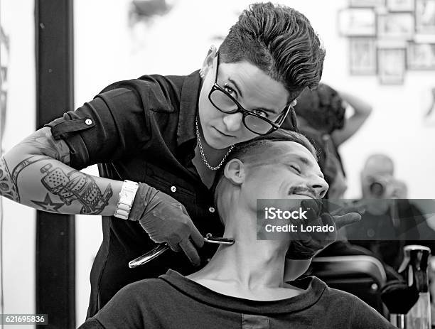 Female Barber Tattooed Woman Styling Attractive Threatening Moustachioed Male Victim Stock Photo - Download Image Now