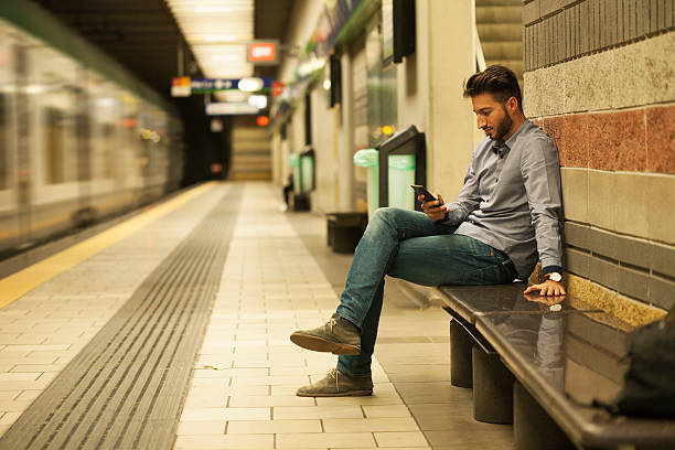 istock Businessman using mobile phone at metro station 621696964