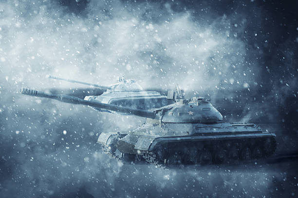 istock Two battle tanks moving in a snow storm 621697994