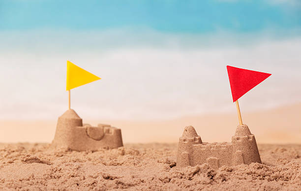 istock Sandcastles with checkboxes close-up on background of the sea. 621698452
