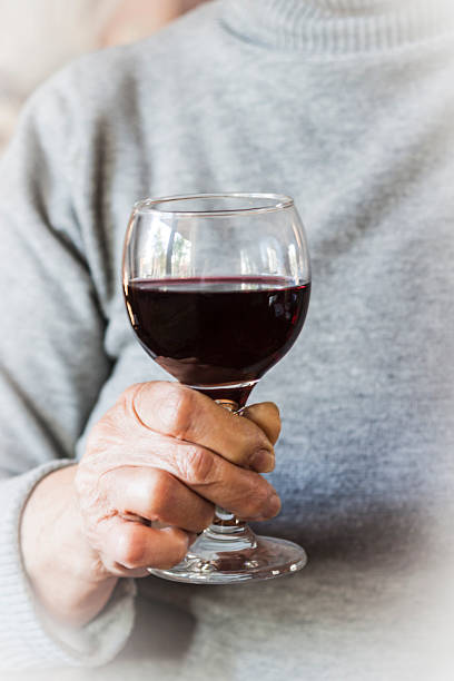 istock Hand holding a glass of red wine 621699160
