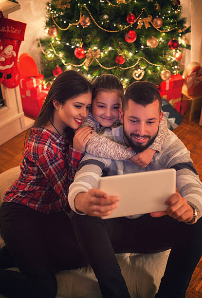 istock Smiling Family Using Digital Tablet on Christmas Eve 621699264