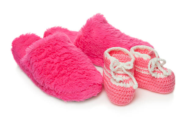 istock Baby booties and  mom's  slippers 621699294