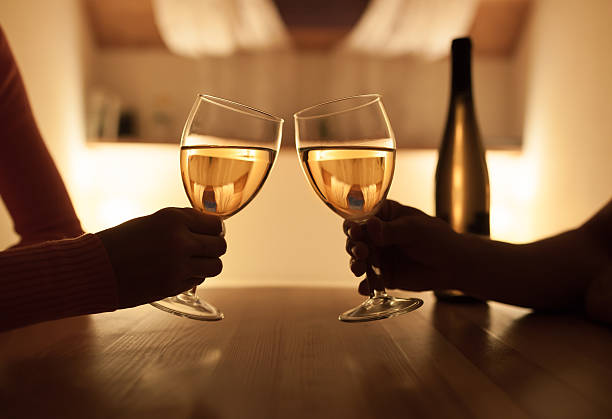 couple enjoying evening drink - wine bottle wine residential structure alcohol imagens e fotografias de stock