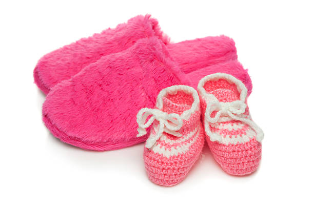istock Baby booties and  mom's  slippers 621699544