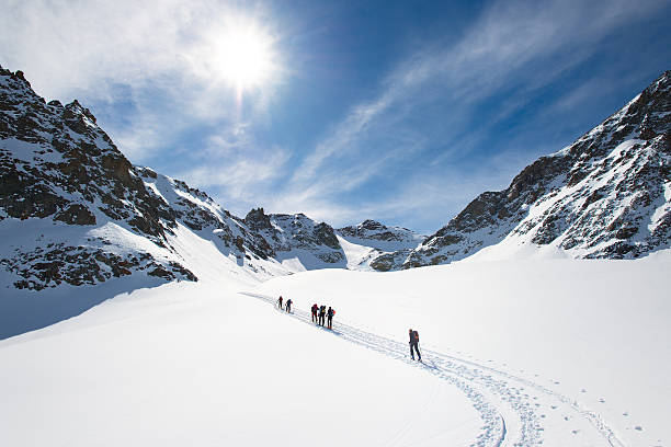 istock Group of climbers roped to the summit 621700028