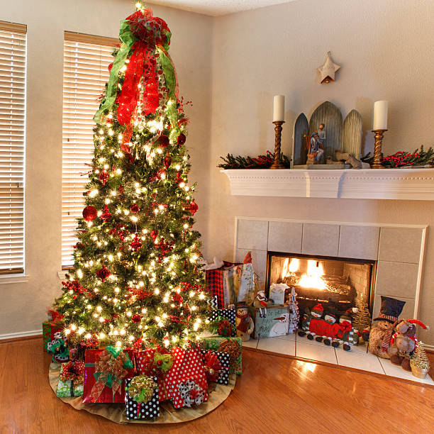 Christmas tree with wrapped gifts next to a fire place