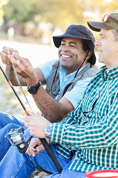 istock Diverse male friends fish together 621702838