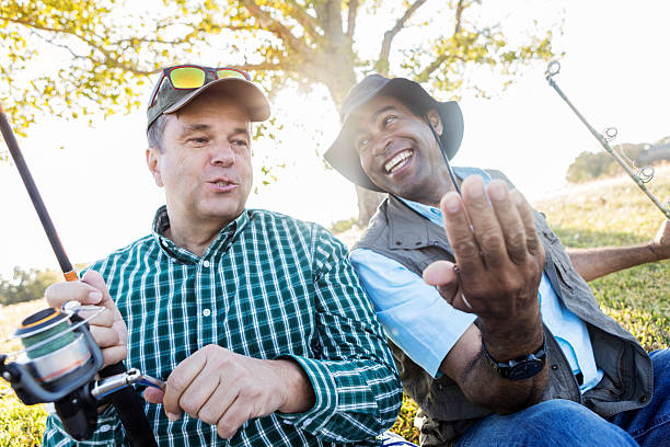 istock Fishermen talk while fishing at a pond 621702854