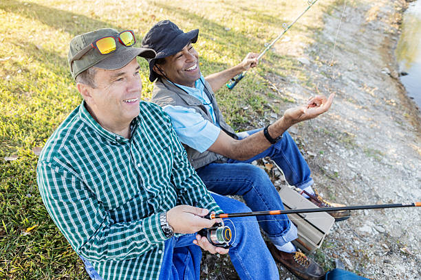 istock Happy fisherman relaxing at a pond 621702866